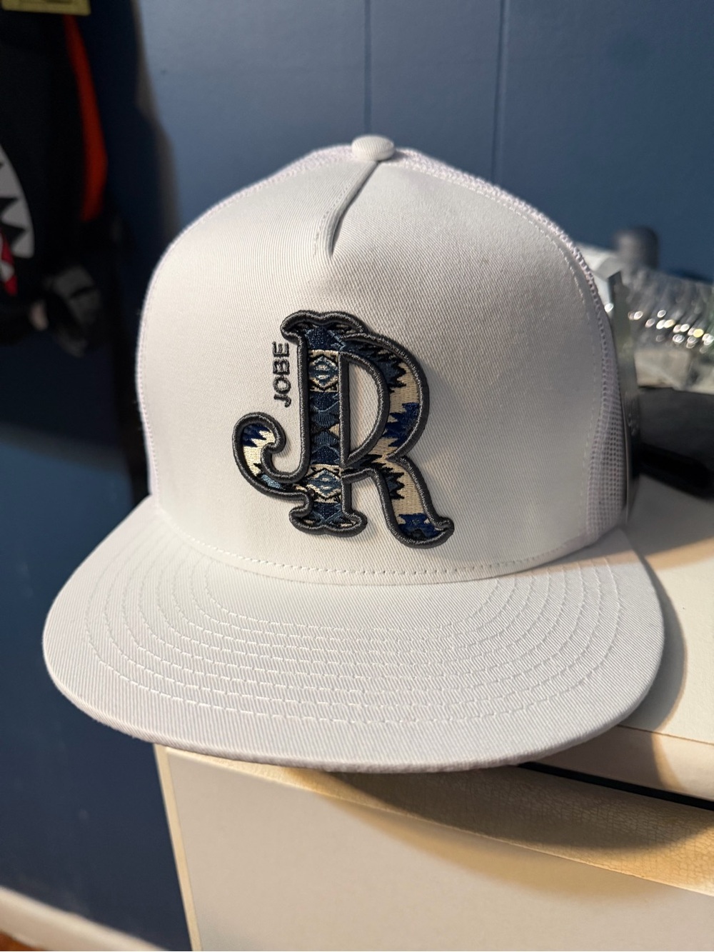 Joe B White Trucker Hat with Blue Patterned 'R' Patch